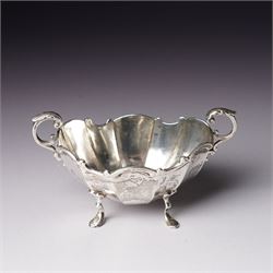 Pair of late Victorian silver salts of oval panel sided design with scroll handles and shaped supports Birmingham 1899 Maker Henry Matthews and two later silver salt spoons 