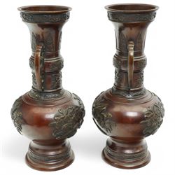 Pair of Japanese two-handled bronze vases, of baluster form with elongated neck, decorated with a raised pattern of birds and flowers, H26cm (2)