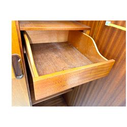 William Lawrence - mid-20th century teak double wardrobe, upper storage section over twin doors featuring recessed handles and contrasting horizontal panel, enclosing hanging rail compartment, towel rail, mirror, shelves and drawer, on plinth base with concealed castors