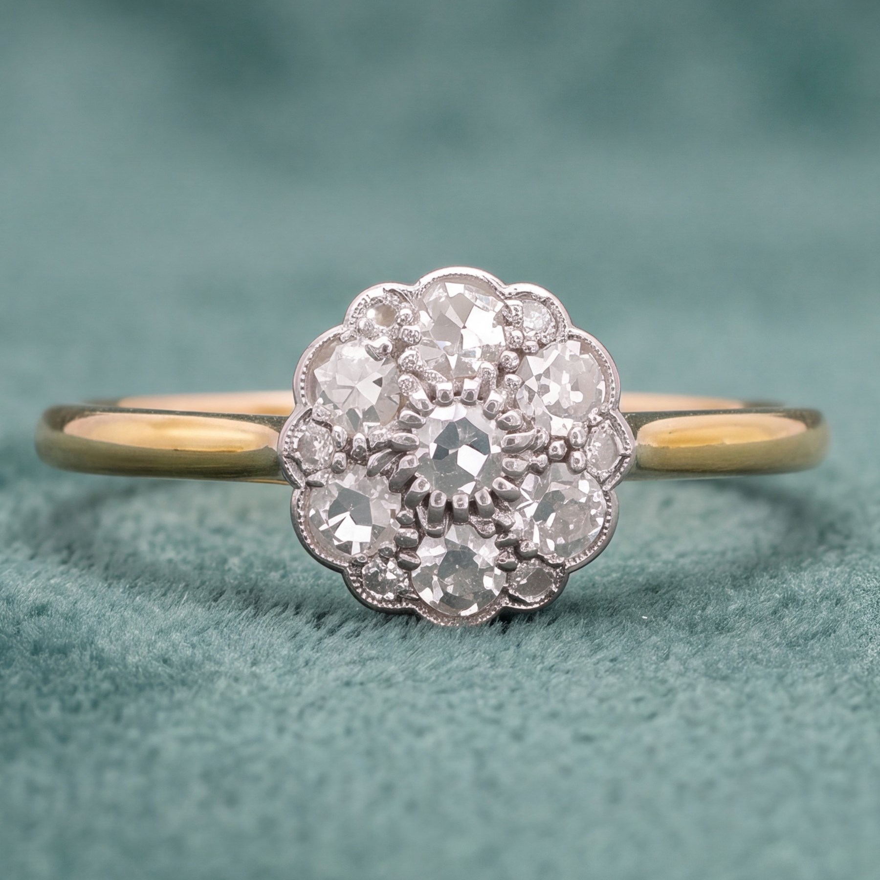 Early 20th century diamond daisy cluster ring, milgrain and bead set with thirteen old cut diamonds by Ahronsberg Brothers, stamped 18ct, total diamond weight approx 0.45 carat