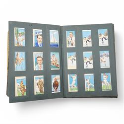Large collection of cigarette cards, comprising approximately seventeen albums including RAF badges, Association Footballers 1935-1936, Air Raid Precautions, Motor Cars, and various other 'Wild Woodbine' boxes 
