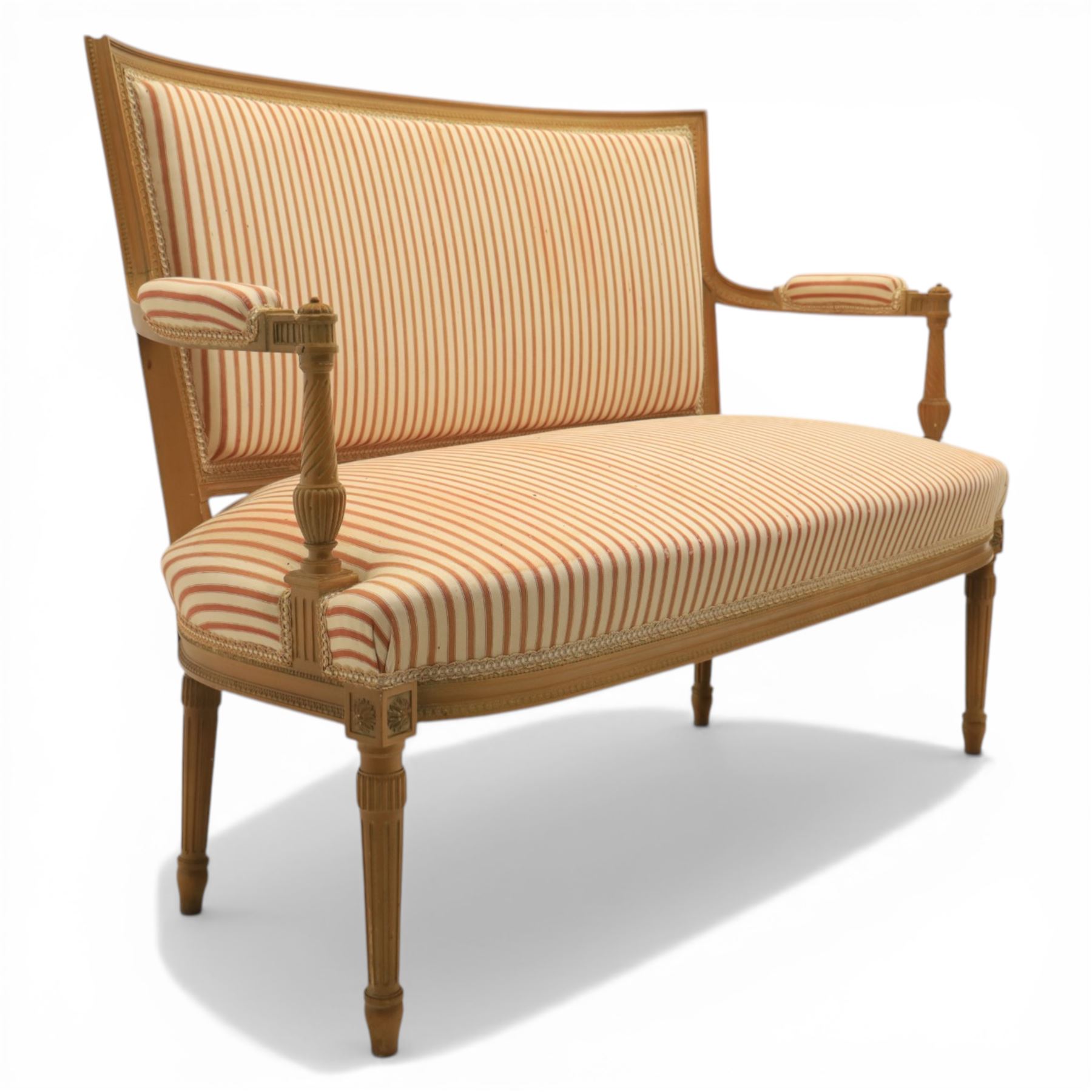 20th century Louis XVI style beech salon suite, comprising settee and four chairs, the settee with shaped rectangular back and upholstered arms over a shaped seat, the chairs with rectangular backs and overstuffed seats, each upholstered in striped fabric with close-nailed borders, upon fluted tapering supports headed by carved paterae, terminating in toupie feet, chairs H89cm W47cm