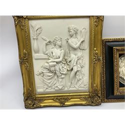 Composite marble effect plaque, moulded in high relief with two classical figures, in gilt frame, overall H51cm L40cm, together with another smaller example, the circular plaque also depicting a classical scene, in part gilded box frame, overall H34.5cm L34.5cm