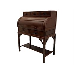 Hardwood cylinder desk, three drawers raised over curved lid, fitted interior with slide, the supports joined by undertier with fret work brackets 