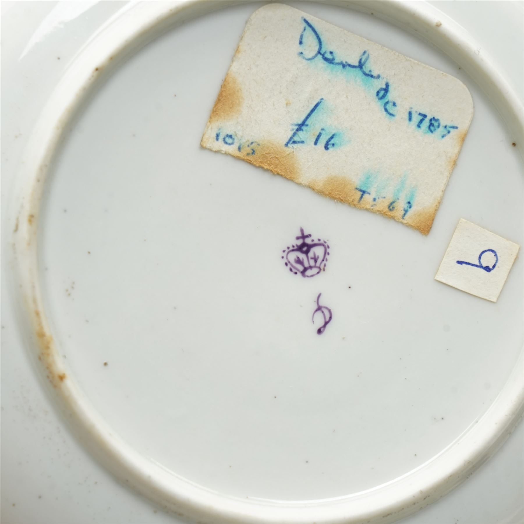Two sets of Derby tea wares, comprising two saucers, teacup and small bowl, decorated in blue and white, with teardrop and swag motifs, heightened with gilt, one set marked pattern no. 34,  with late 18th century D mark in puce, the other with crown, D mark and crossed batons in puce (4)