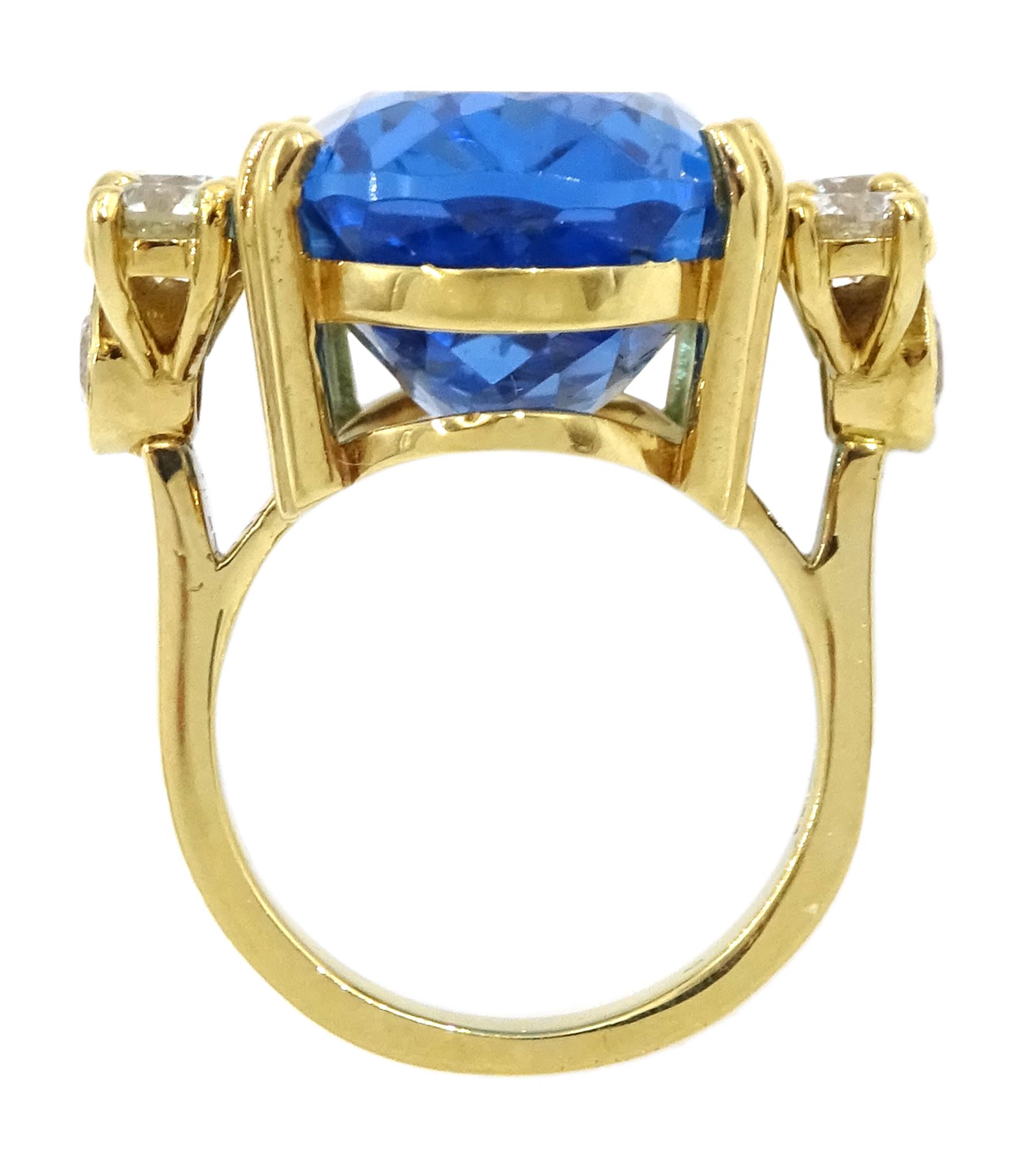 18ct gold blue topaz and diamond ring, single oval cut blue topaz of approx 31.10 carat, with four round brilliant cut diamonds set either side and a further two diamond set to the gallery, London 2019, total diamond weight approx 2.25 carat