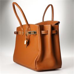 Hermès - gold hardware 'Birkin 35' handbag in gold Togo leather with white stitching, featuring gold-plated hardware, double rolled handles, front flap, belted turn-lock closure, and leather lining with one zip and one slip pocket, stamped 'Hermes Paris Made in France' in gold, with blind-stamp Q (2013) with craftsman’s code 70A to the underside of locking belt. Accompanied by: padlock, keys, clochette, Hermes dust bag, booklet, and ribbon. New unused condition.