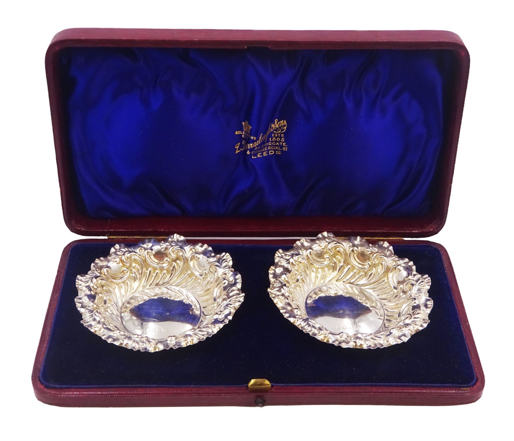 Pair of Victorian silver bon bon dishes, each of circular form, with shaped rim and repousse scroll decoration, hallmarked Fenton Brothers Ltd, Sheffield 1897, in tooled leather velvet and silk lined fitted case