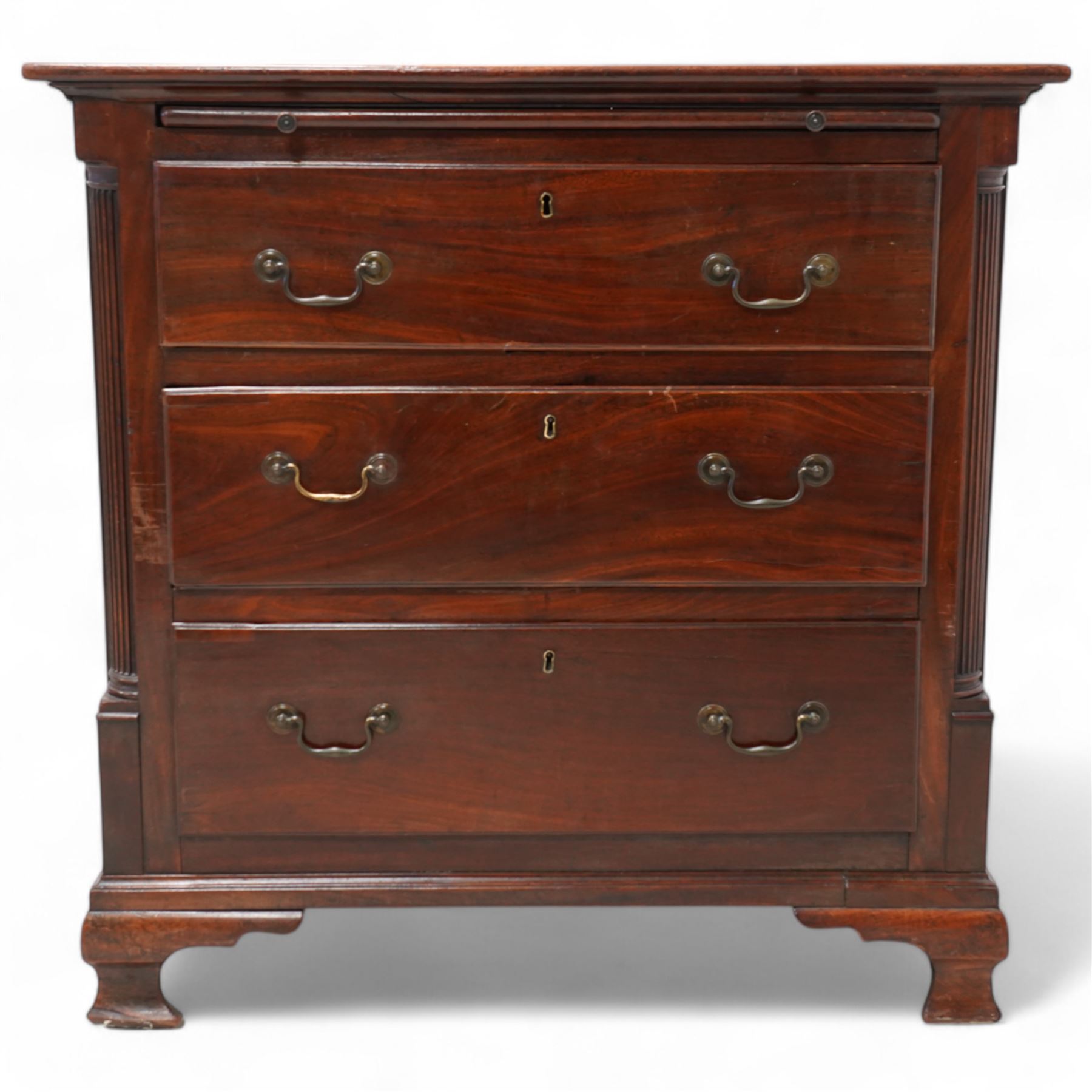 Georgian mahogany bachelor's chest, brushing slide over three long drawers, enclosed by canted corners with fluted quarter columns, on ogee bracket feet