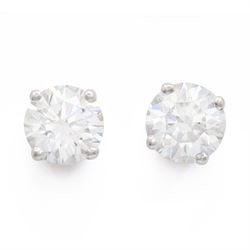 Pair of platinum diamond earrings, each stud set with a single round brilliant cit diamond...