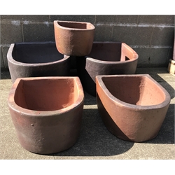  Two large 'D' shaped rustic frost proof pots (W51cm, H33cm, D61cm), two similar medium 'D' shaped frost proof pots (W43cm, H26cm, D46cm) and a small pot (W32cm, H21cm, D35cm) (5)  