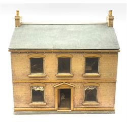 Victorian pine doll's house of double fronted two-storey form with brick painted facade and chimney stacks and grey painted pitched roof, the central four-panel door opening to reveal a hall with tin-plate staircase and privy under, landing and two rooms on each floor with glazed windows and fire-surrounds, some scrap-work to the interior and three removable panels to the back; together with small quantity of later oversized furniture H57cm W57cm D25cm