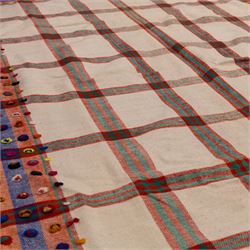 South West Persian Jajim flatweave kilim, ivory ground, woven with a bold checked and striped design in red and green, bordered by wide geometric polychromed bands decorated with circular tufts 