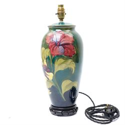 Moorcroft 'Hibiscus' pattern table lamp on green ground, including stand and fittings H42cm