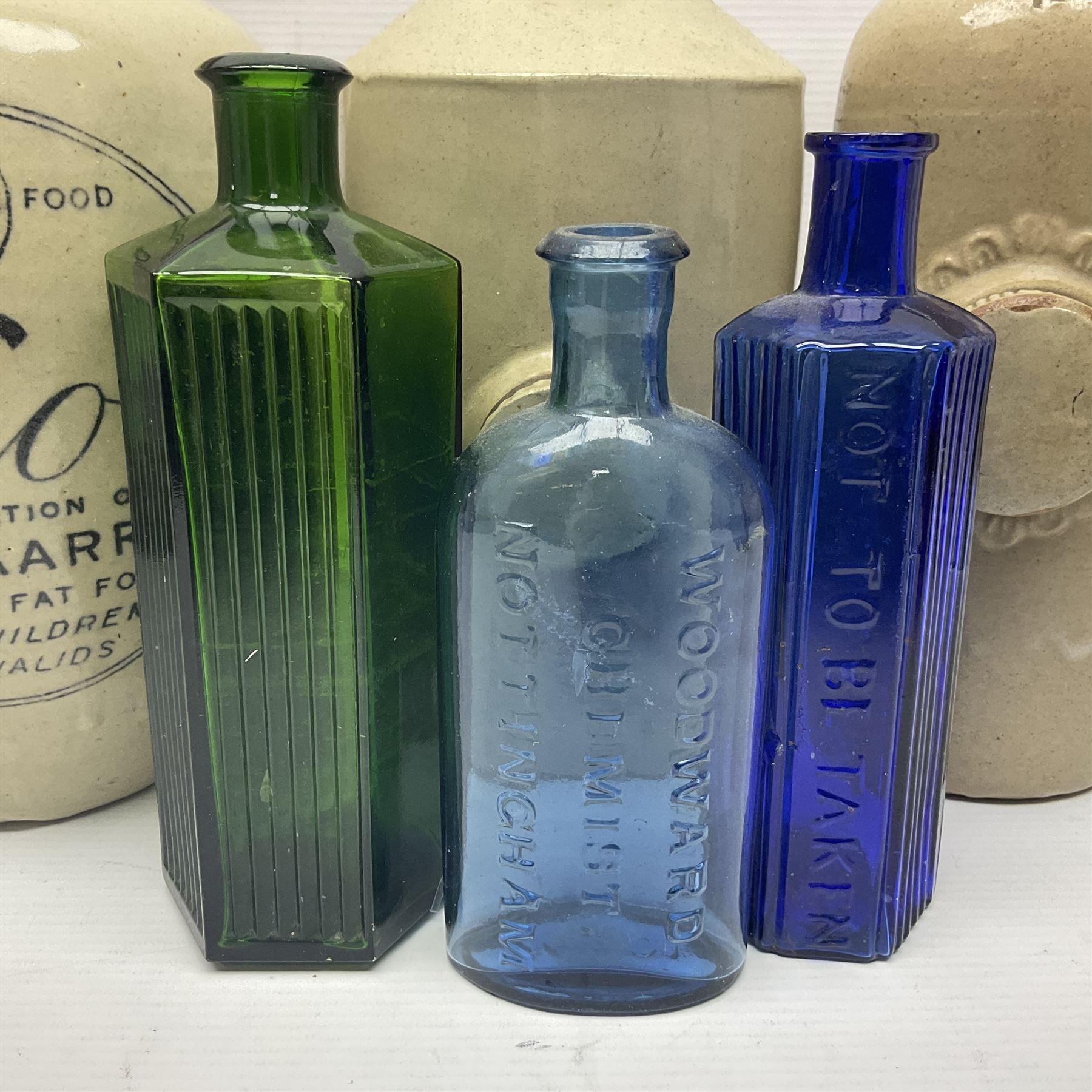 Virol bone marrow stoneware jar, two stoneware hot water bottles and a collection of small apothecary bottles to include amber and green glass examples, some with stoppers and labels, jar H24cm