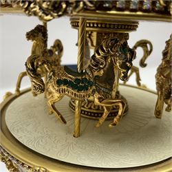 Franklin Mint House of Faberge; The Faberge Imperial Carousel Egg, with a carousel that revolves to the sound of the musical box operated by the winding key finial, H27cm