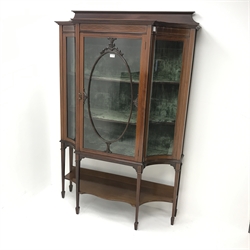 Edwardian inlaid mahogany display cabinet, raised shaped back,  concaved corners flanking single glazed doors enclosing lined interior with two shelves, square tapering supports joined by solid undertier on spade feet, W122cm, H182cm, D44cm