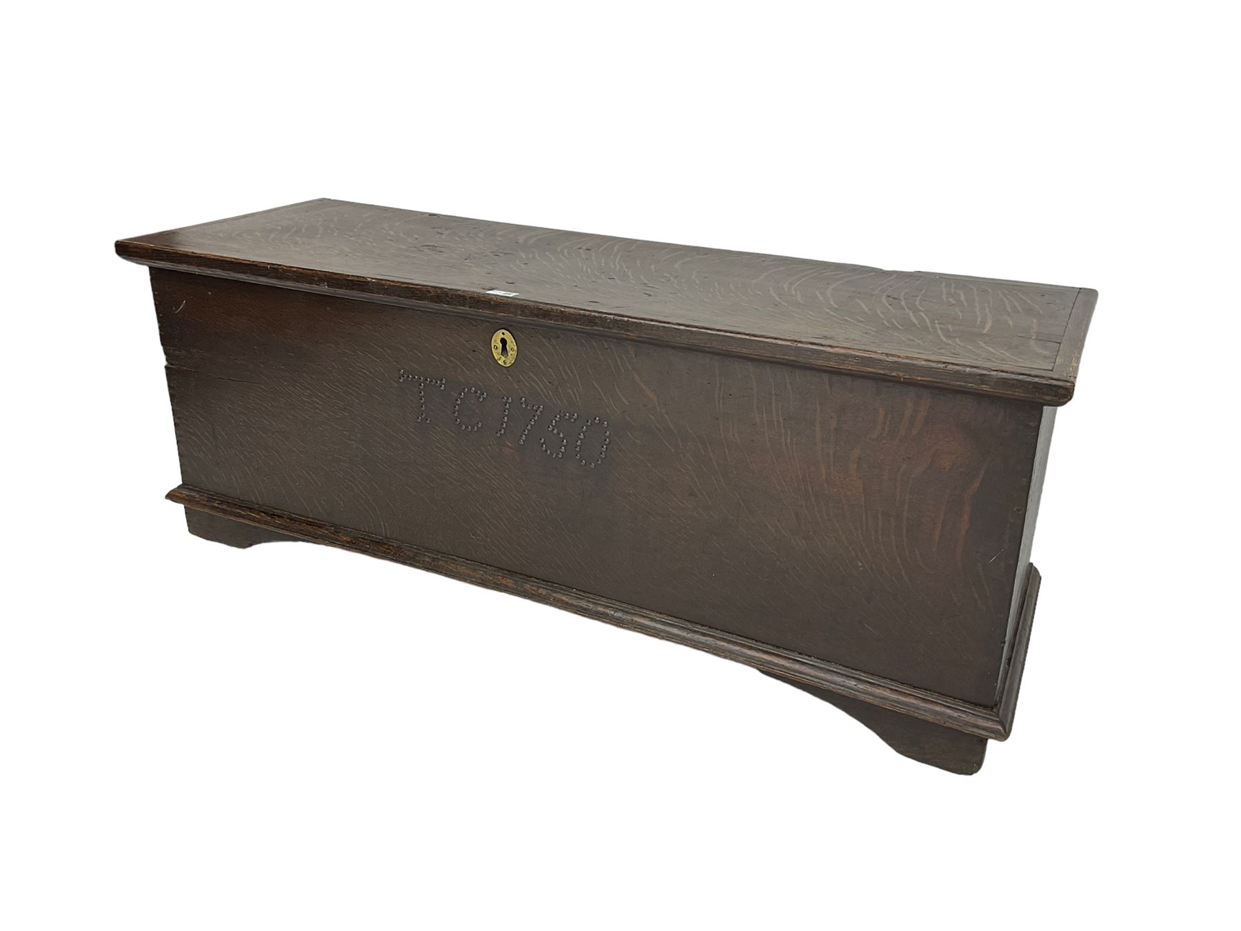 18th century oak sword chest or coffer, hinged lid with moulded edge and iron fittings concealing candle box and main compartment, the front with studwork spelling 'TC 1750', raised on bracket feet