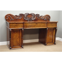 William lV mahogany twin pedestal sideboard, raised shell and acanthus carved back above break front top, three drawers, two figured panelled cupboards, scrolled pilasters, W193cm, H125cm, D67cm  