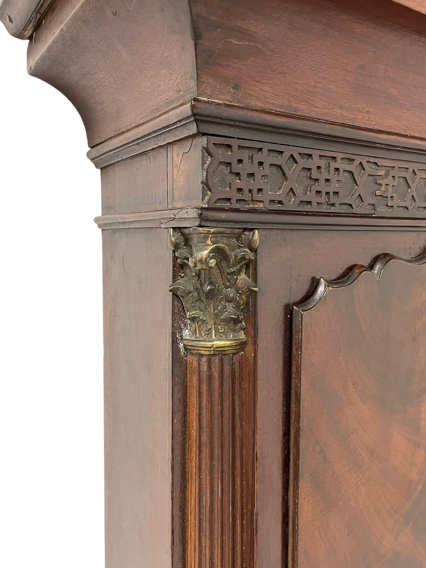 W. Phillips of Bromyard - 8-day mahogany longcase with a painted moon roller dial, c 1790,
swans neck pediment with dog tooth moulding, raised carving and  brass paterie, break arch hood door beneath flanked by reeded pilasters with brass Corinthian capitals, trunk with a blind fret, reeded quarter columns and long wavy topped door,
Plinth with a deep moulding and canted corners raised on a shaped base, painted dial with gesso spandrels, Roman numerals, five minute Arabic's and minute dots, with steel hands, seconds dial and square date aperture, dial pinned to a rack striking movement with an anchor escapement, striking the hours on a cast bell. A clockmaker by the name of John Phillips is recorded as working in Bromyard (Worcs)  in the early to mid 18th century, certainly by 1770-90. W. Phillips was possibly an unrecorded son or brother also working in the same family clockmaking business during the later part of the 18th century.
