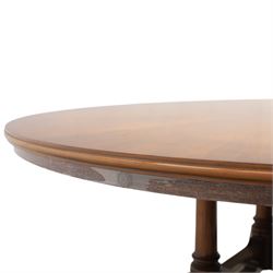 Bevan Funnell Reprodux - Regency design mahogany extending dining table, circular radial veneered top with central fan inlaid patera, on turned pedestal with four reeded downswept supports terminating in brass caps and castors, with six addtional leaves in a fitted storage case