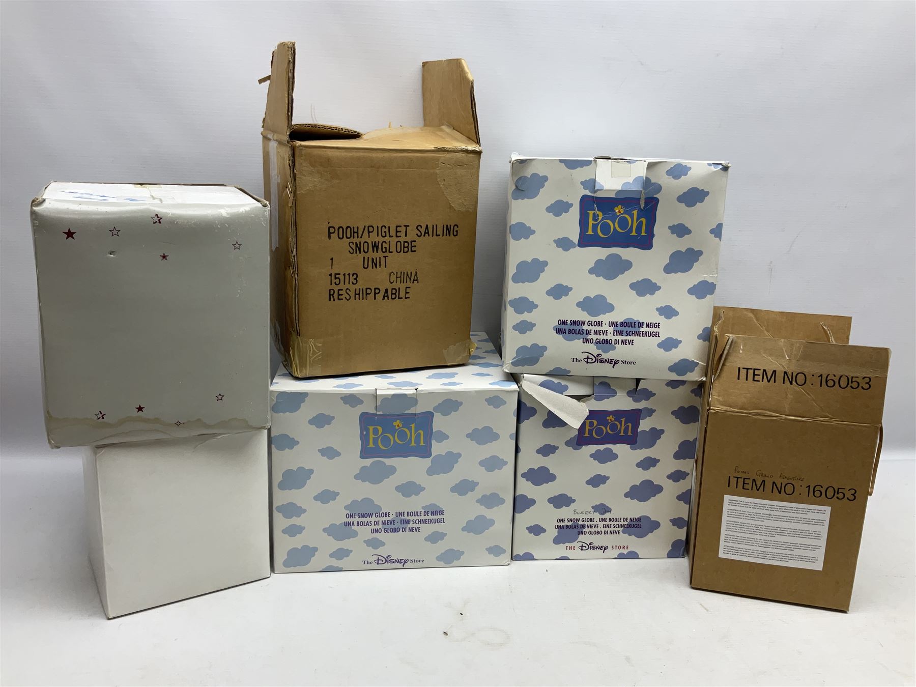 Five Disney Winnie The Pooh snow globes, to include Pooh and Piglet Sailing, Pooh's Grand Adventure and Blustery Day, together with The Walt Disney Classic Waterglobe collection globe and group Tigger, Winnie and Piglet figure under dome, all with boxes (7)