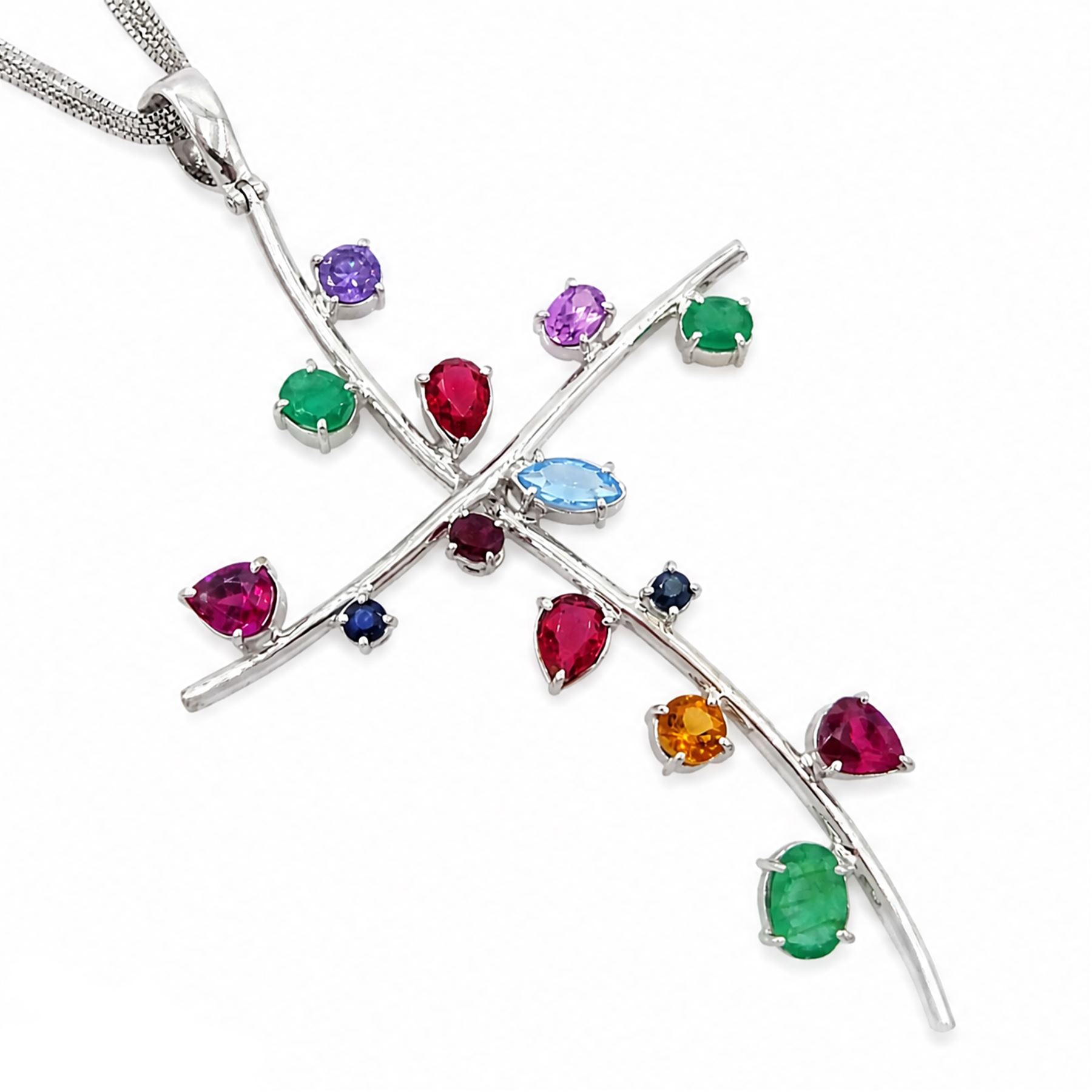 18ct white gold multi gemstone cross pendant necklace, vari-cut stones including emerald, ruby, pink and blue sapphire, red and blue stones, on a four strand box link chain necklace, stamped 750