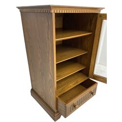 Ercol - mid-20th century dark elm 'Old Colonial' music cabinet, single glazed door enclosing three shelves, single drawer fitted to base