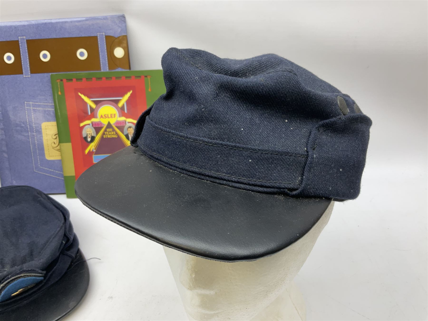 Black painted three colour railway lamp with revolving filters, H29cm; BR Acme Thunderer whistle; three railway peaked caps, two with BR Intercity 125 badge; small album of photographs of railway interest etc