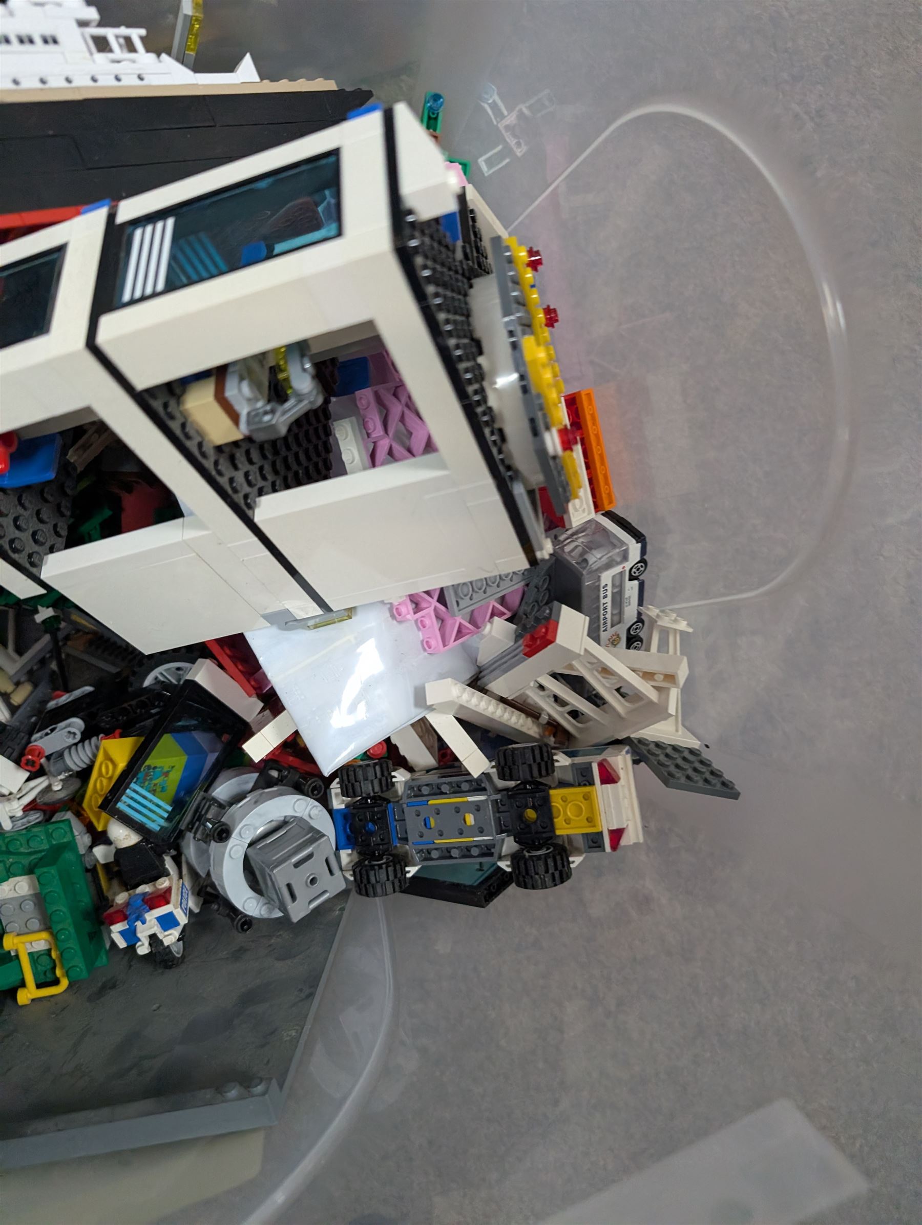 Two boxes of partially built Lego vehicles, including Lego Technics Dumper Truck no. 8264, Titanic, container ships, police boat, smaller police vehicles, etc