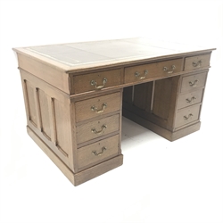 Edwardian oak twin pedestal partners desk, brown leather inset top, twelve drawers, two cupboards, plinth base, W140cm, H77cm, D91cm