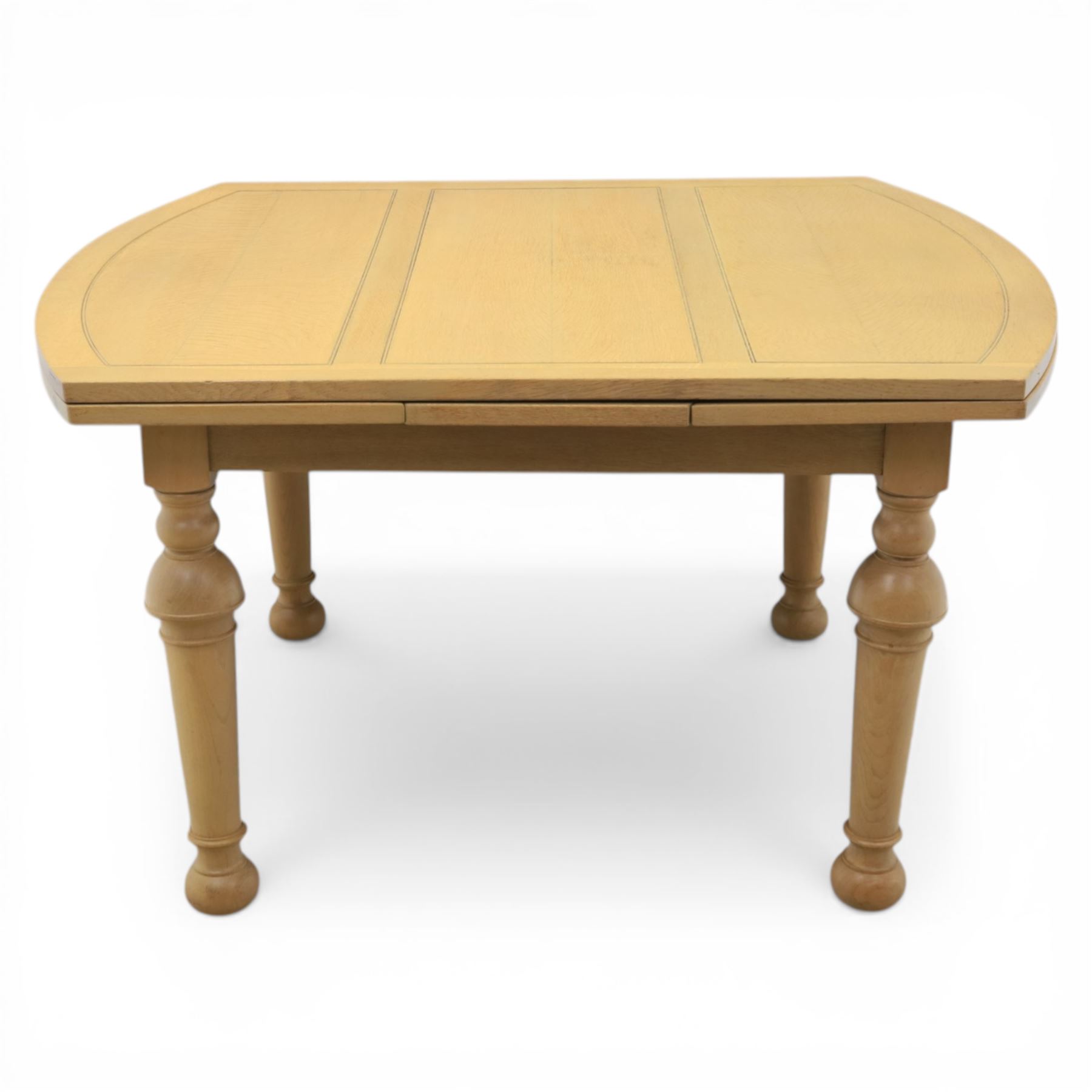 Edwardian light oak extending dining table, oval-ended rectangular top with panelled decoration and double line borders, draw-leaf extension action to 211cm long, on turned supports