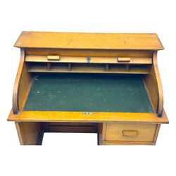 Leeway - late 19th century light oak child's roll-top desk, tambour top opening to reveal fitted interior with green felt writing surface and five pigeonholes, over three graduated drawers on the right side, raised on panelled side supports