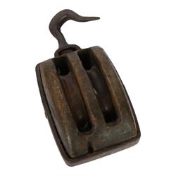 19th century double-sheave wooden pulley block in a metal casing, fitted with an iron hook, stamped GIS to one side, including hook L36cm