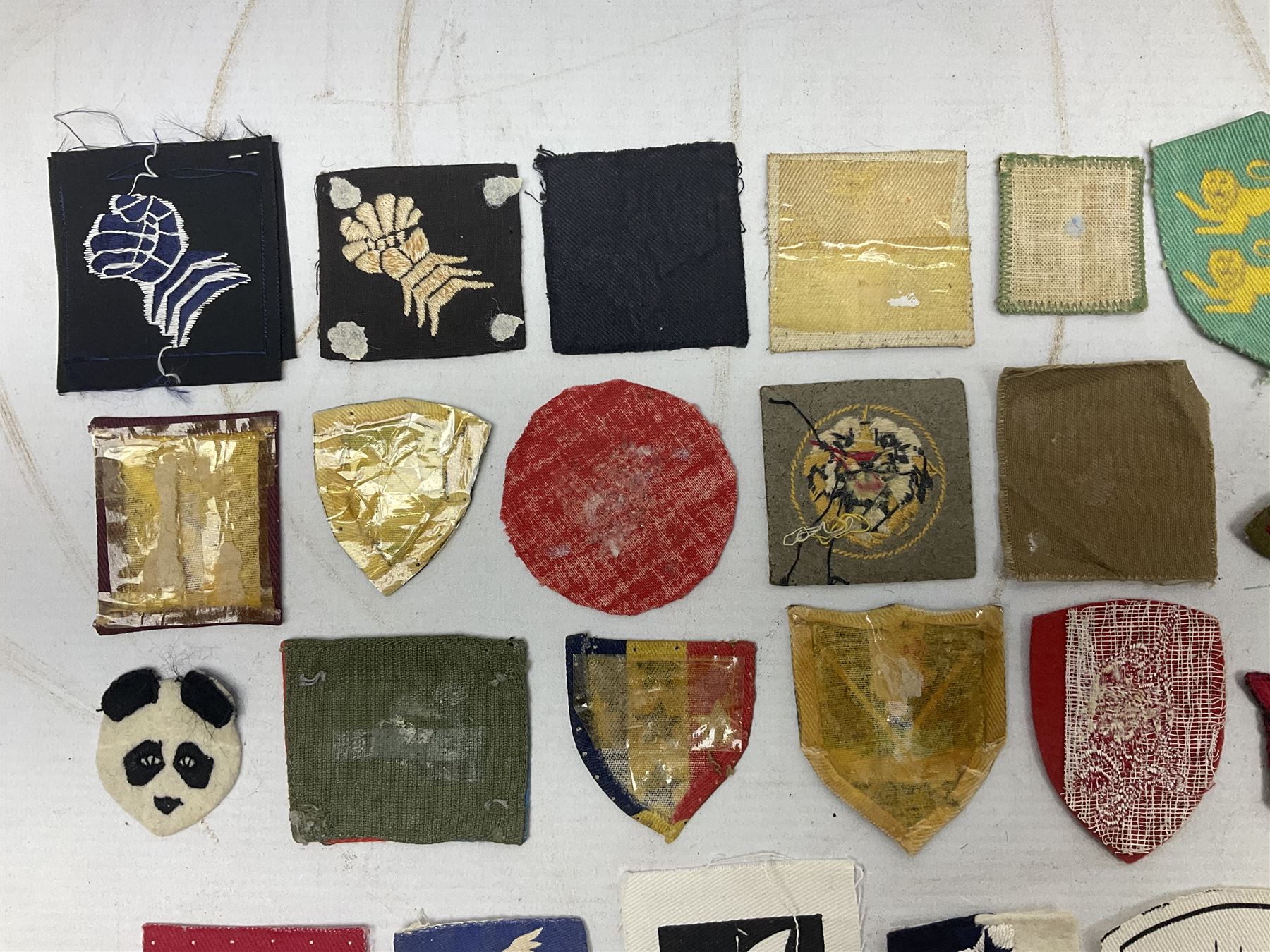 Approximately one-hundred printed and embroidered cloth badges including Royal Tank Regiment, Royal Armoured Corps, 219th Independent Infantry Brigade, Cyrenaica, Cyprus, Singapore and other districts, Gibraltar Garrison, East Anglian Brigade, 20th Armoured Brigade and various armoured divisions etc