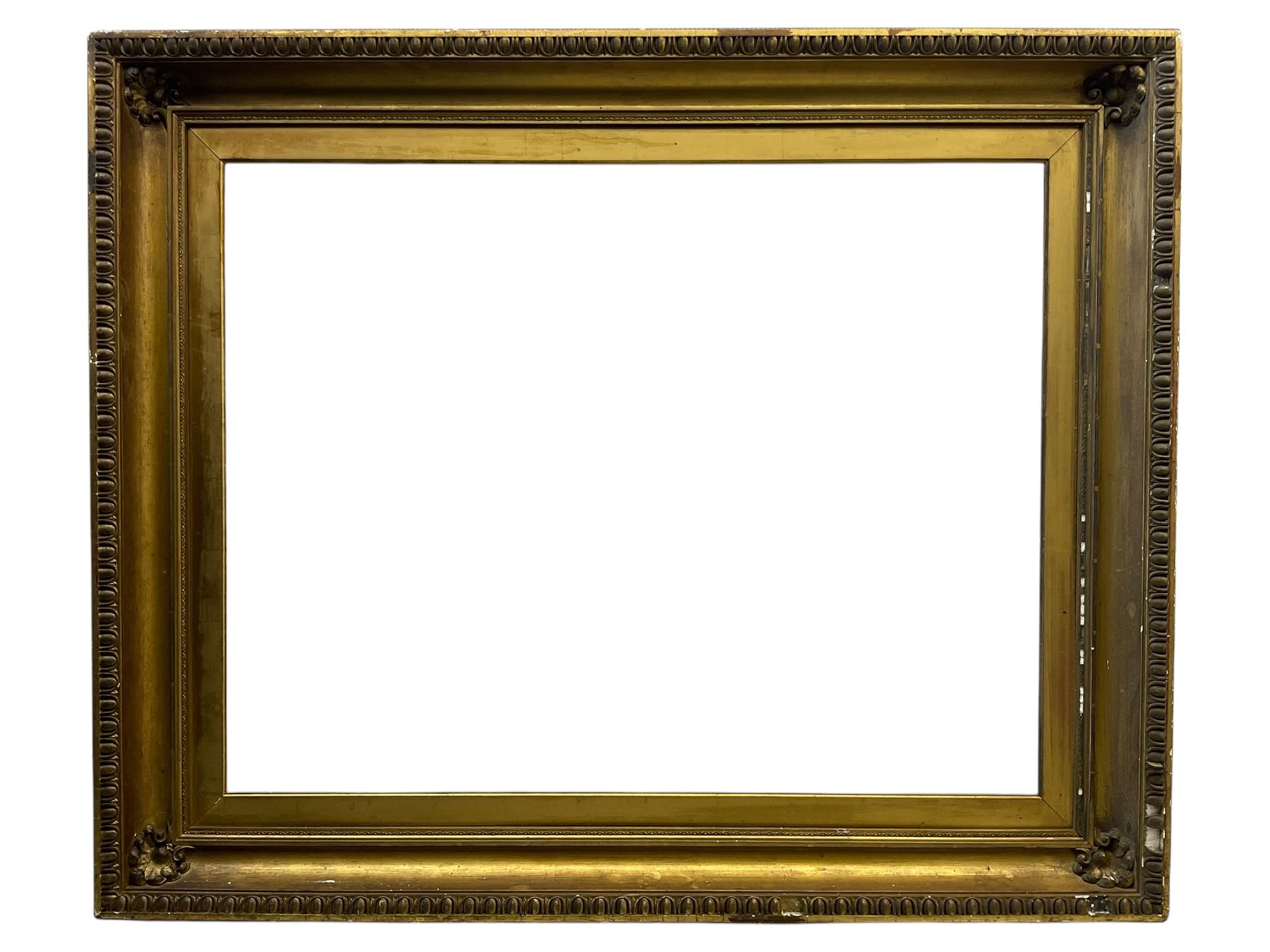 Large early 20th century gilt picture frame, with floral moulded corners and egg and dart moulding to the edge, aperture 78cm x 98cm, inner slip aperture 70cm x 91cm, overall 97cm x 118cm