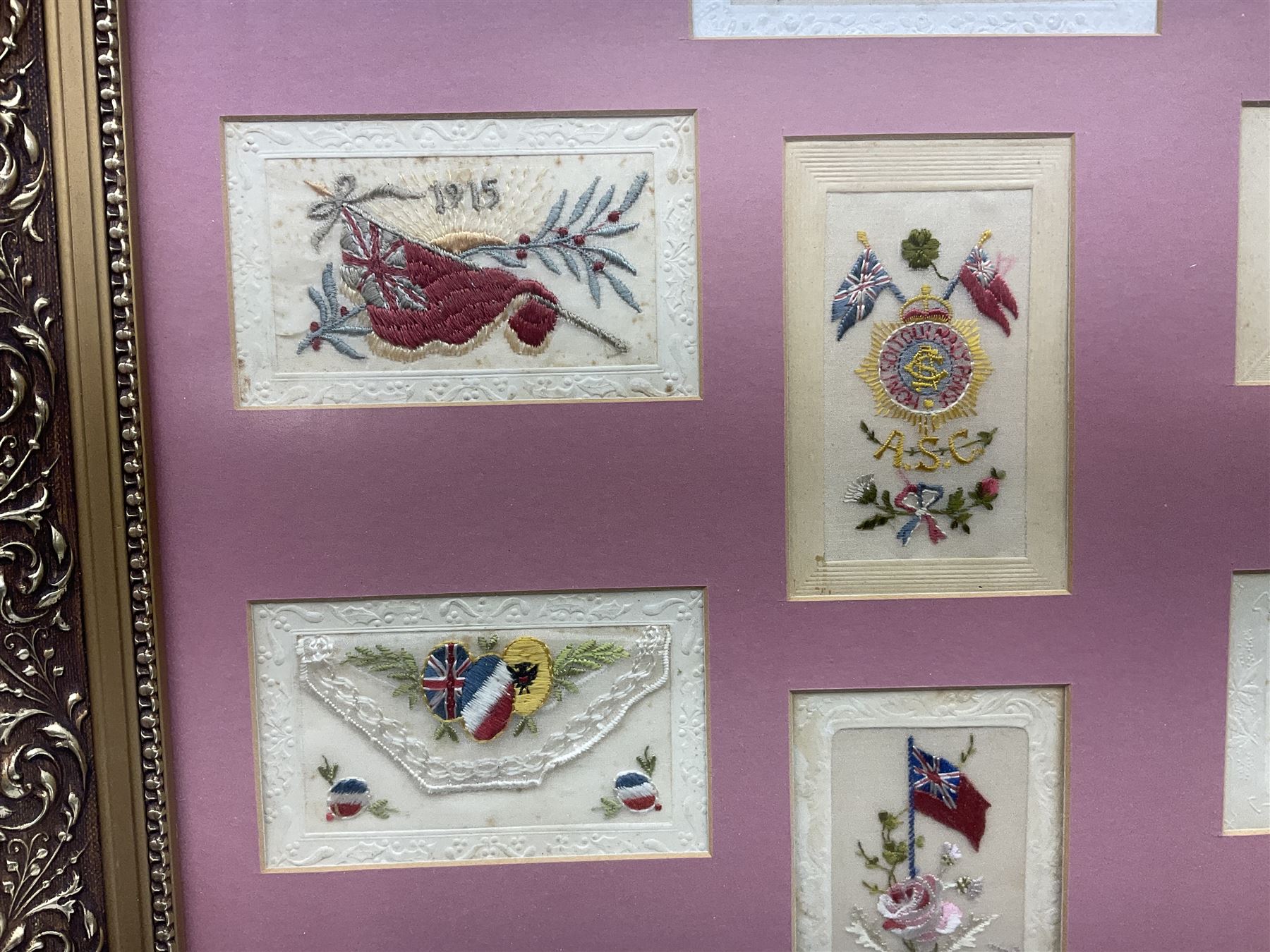 Thirty-five WW1 embroidered silk postcards including regimental crests, flags of the Allies, envelope type with greeting card inserts, Christmas and birthday cards etc; mounted and glazed in three graduated modern matching gilt frames (3)