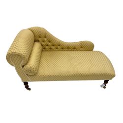 Small Victorian style chaise longue, upholstered in gold lozenge patterned fabric, on turned feet with brass castors