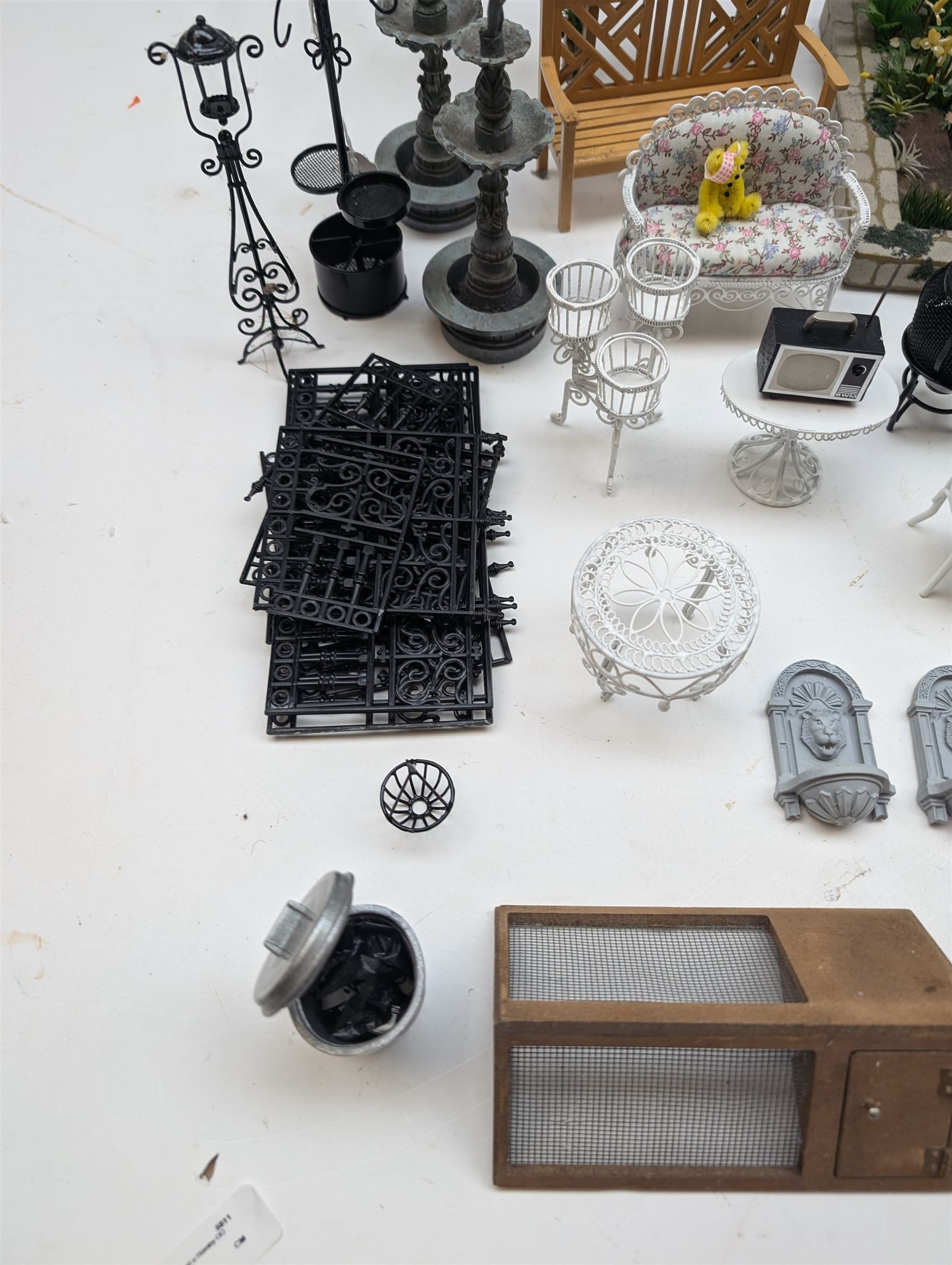 1:12 scale dolls house conservatory and garden accessories, including white wooden glazed conservatory on a stone effect base, black and white metal garden seating, barbecue, plant shelves, parasol, barbeque accessories, large planters, rabbit hutch, animals, chimenea, etc