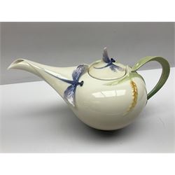 Franz Teapot decorated with dragonflies, together with a matching sucrier and cover and a cup and saucer in Iris pattern, all with printed mark beneath 