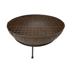 Circular riveted iron fire pit, strapwork sides with twin handles on stand, with grate
