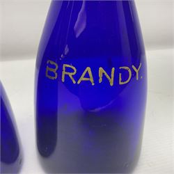 Pair of early 19th century blue glass decanters with teardrop stoppers, with gilt writing, the first marked Gin the second Brandy 