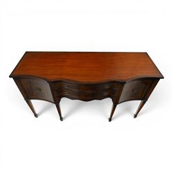 Georgian design mahogany serpentine sideboard, shaped top over two central drawers flanked by cupboard doors, flame mahogany veneered fronts with satinwood stringing, oval brass handles, shaped apron, on square tapering supports with spade feet