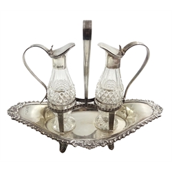  Late Victorian Adams style silver vinegar and oil stand, two silver mounted cut glass bottles on boat shaped stand with gadroon and floral moulded border and central loop handle by Charles Boyton, London 1900 H17.5cm x W22cm   