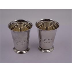 Pair of modern silver cups, each of plain tapering cylindrical form, with fluted rims and upon circular foot, engraved with monograms to body, hallmarked Barker Ellis Silver Co, Birmingham 1976, H8cm