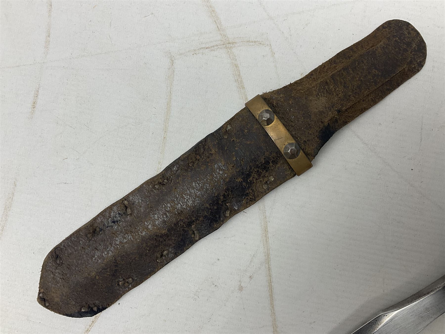 Scratch-built fighting/throwing knife, probably trench art, with 18cm steel spear type blade, plain cross-piece and French Lebel Rifle bayonet grip; in bras mounted studded leather sheath with belt hanger L29.5cm overall