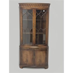 Reproduction Bevan Funnell mahogany double corner cabinet, projecting dentil cornice, two doors enclosing two adjustable shelves, single slide above two cupboards, W88cm, H188cm, D55cm