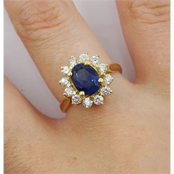 14ct gold oval sapphire and round brilliant cut diamond cluster ring, stamped 14K