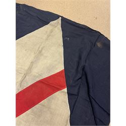 Ship's house flag, rectangular linen flag, with a white diamond and red cross to the centre, upon a cobalt blue ground, inscribed on the hoist 'Cutty Sark', H130cm, W170cm

Provenance by vendor repute: Vendor's father was a naval cadet in 1940s/50s on board HMS Worcester which was moored alongside the Cutty Sark on the River Thames at Greenhithe. He has had the flag since then. 