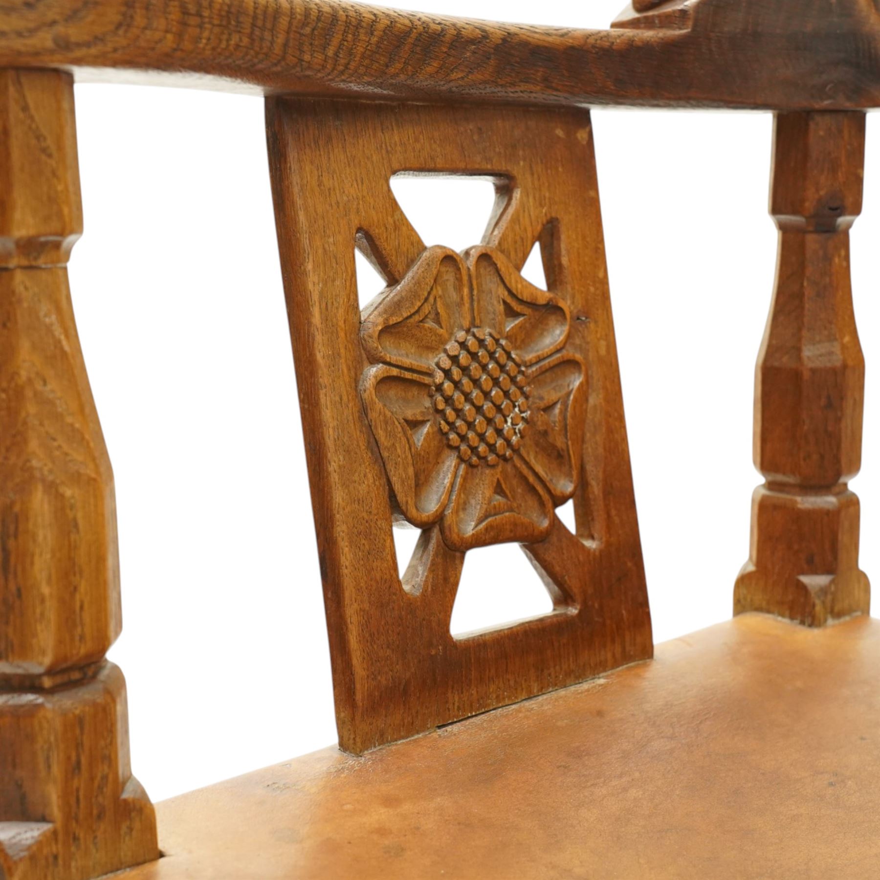 Mouseman - important oak monks chair, c1930s, the curved back inscribed with motto 'Cum Bona Voluntate Servientes' (serving with goodwill) over Trinity College Cambridge coat of arms, the shaped arms terminating with carved monks heads, each pierced side panel with Yorkshire Rose, tan leather seat on four octagonal legs joined by a cross stretcher, the back of the chair with initials ECH, with carved mouse signature, by Robert Thompson of Kilburn